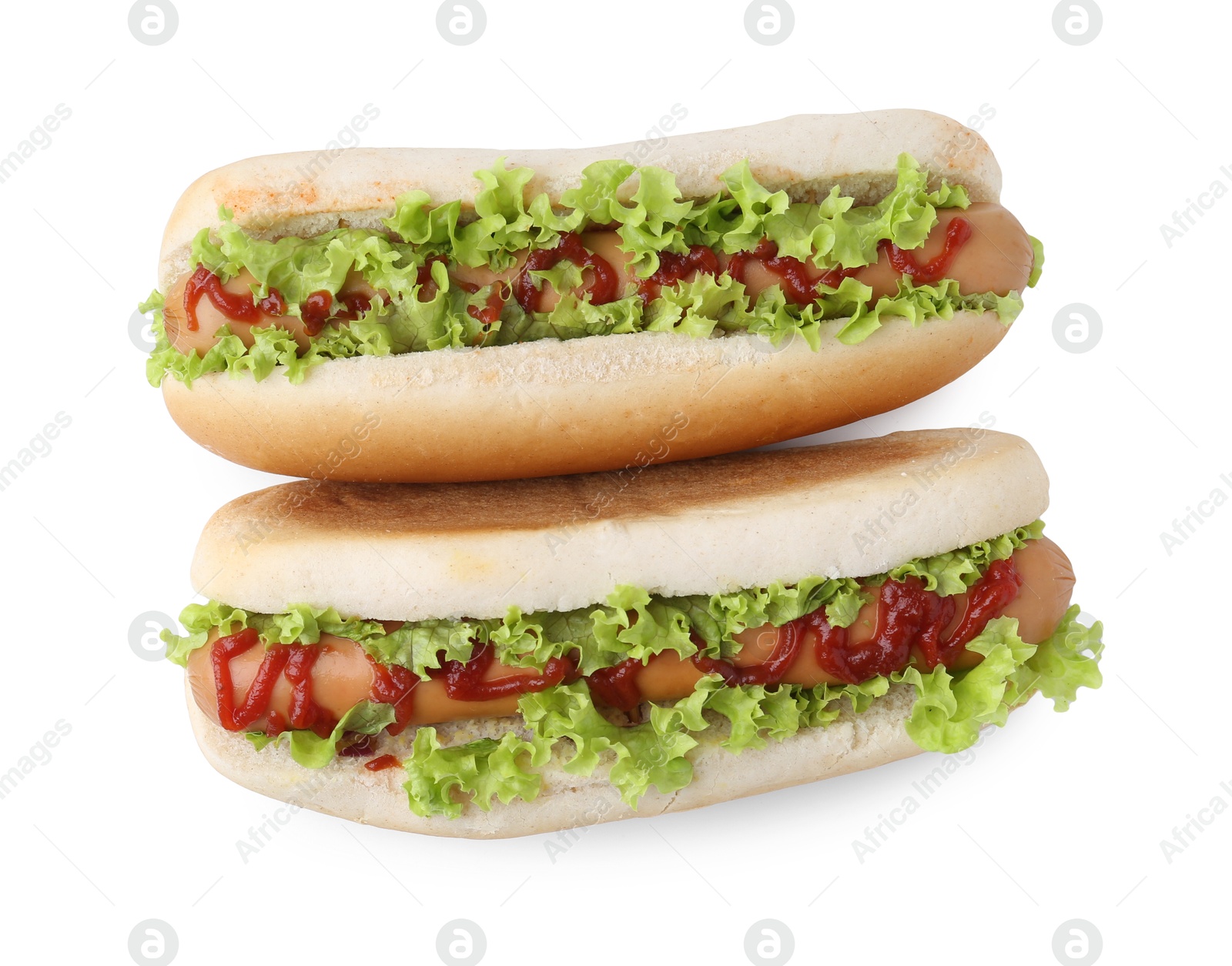 Photo of Tasty hot dogs with lettuce and ketchup isolated on white, top view