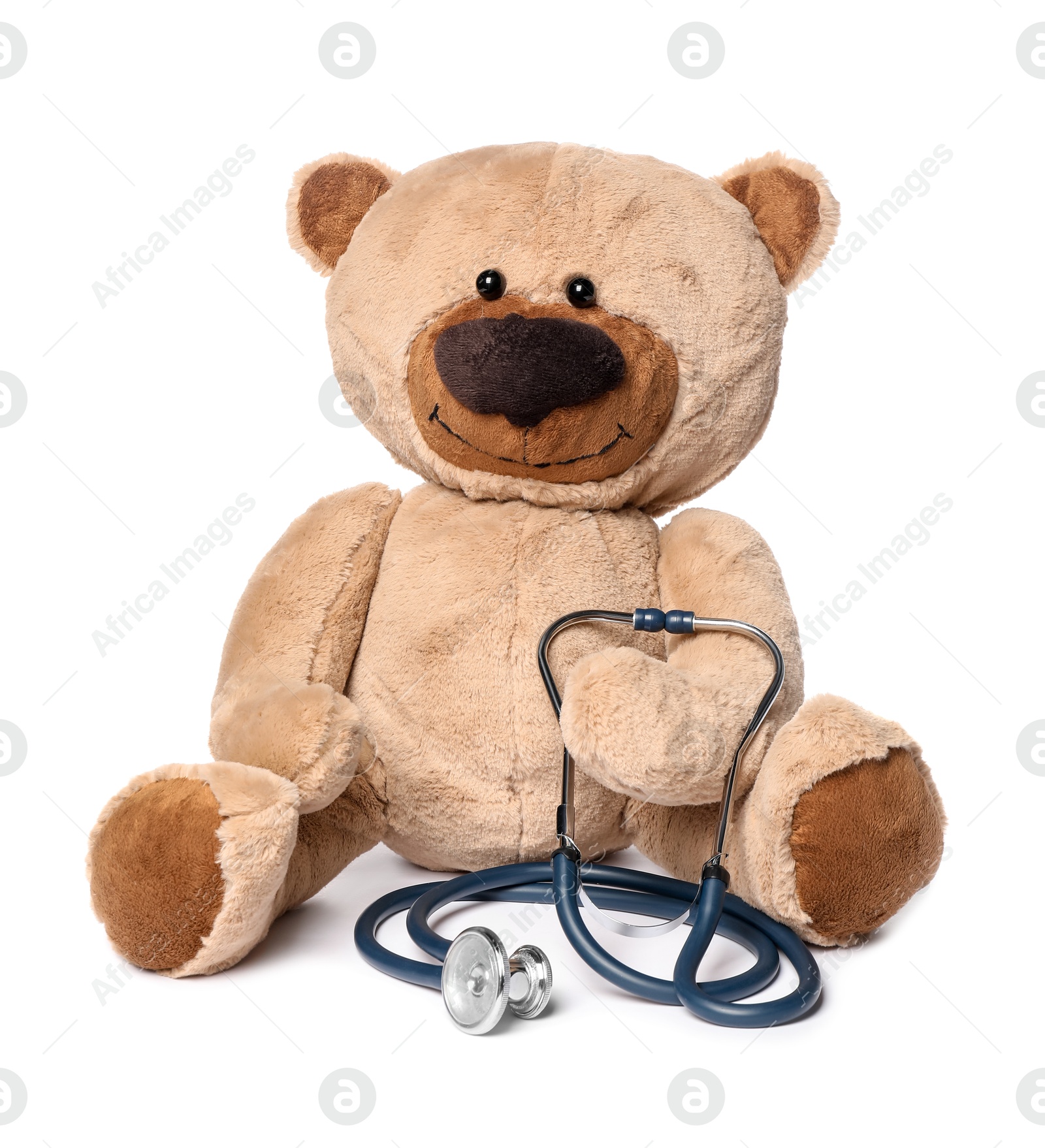 Photo of Pediatrics concept. Teddy bear and stethoscope isolated on white