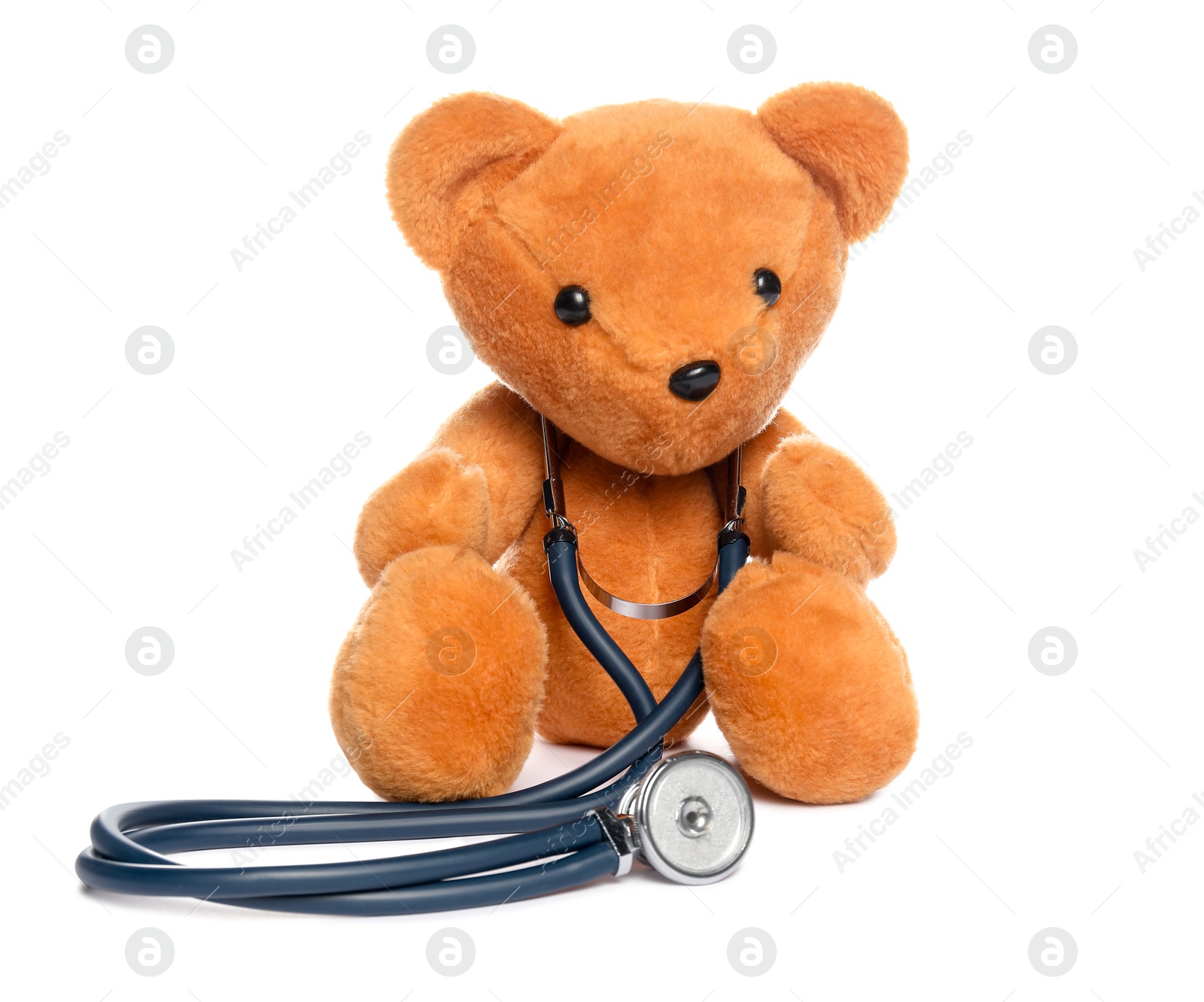 Photo of Pediatrics concept. Teddy bear and stethoscope isolated on white