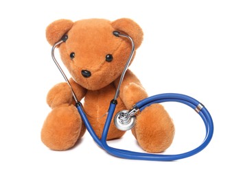 Photo of Pediatrics concept. Teddy bear and stethoscope isolated on white