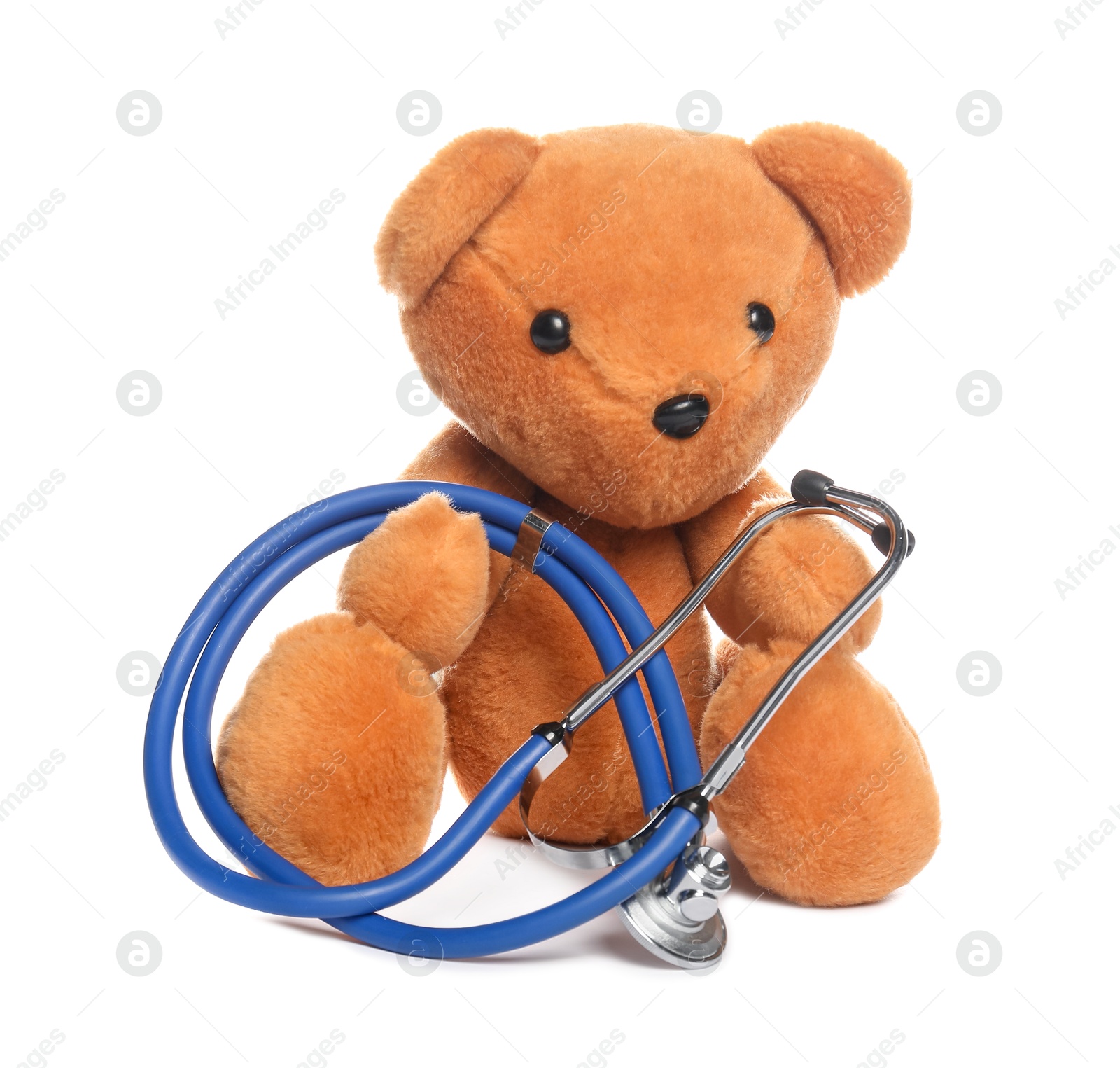 Photo of Pediatrics concept. Teddy bear and stethoscope isolated on white