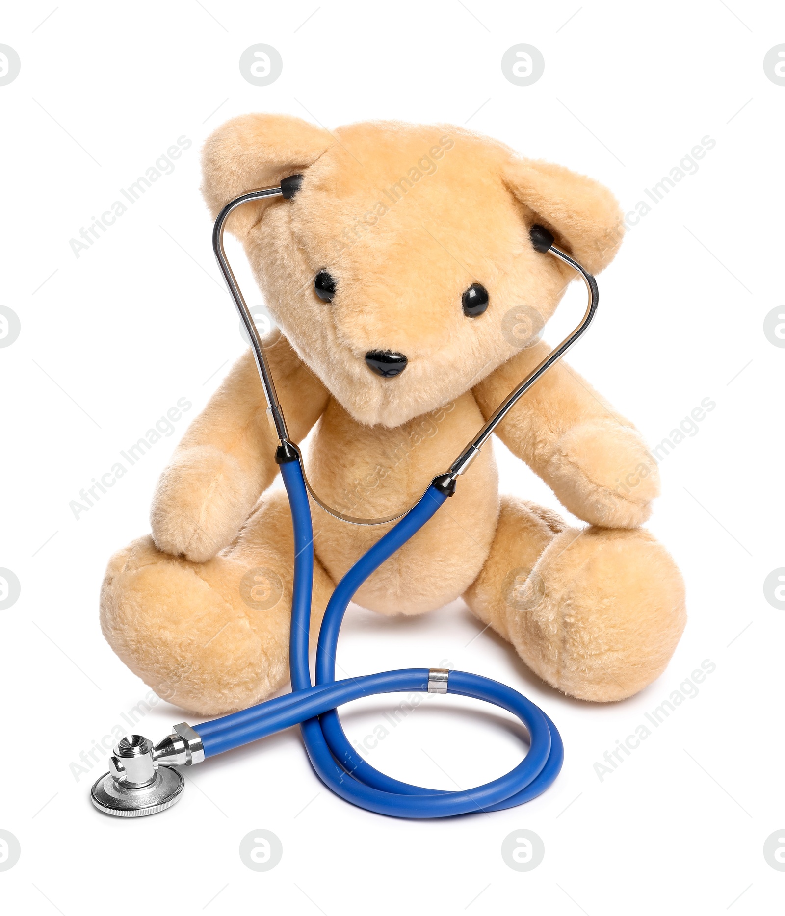 Photo of Pediatrics concept. Teddy bear and stethoscope isolated on white