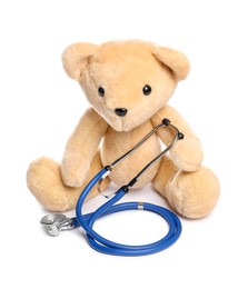 Photo of Pediatrics concept. Teddy bear and stethoscope isolated on white