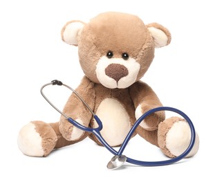 Photo of Pediatrics concept. Teddy bear with stethoscope isolated on white