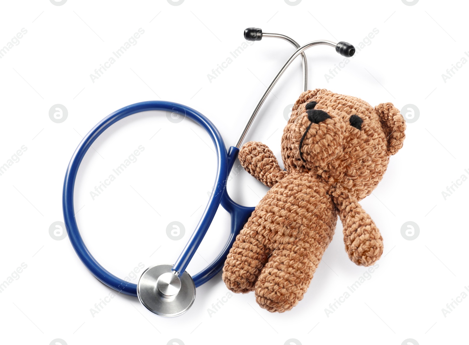 Photo of Pediatrics concept. Toy bear with stethoscope isolated on white, top view