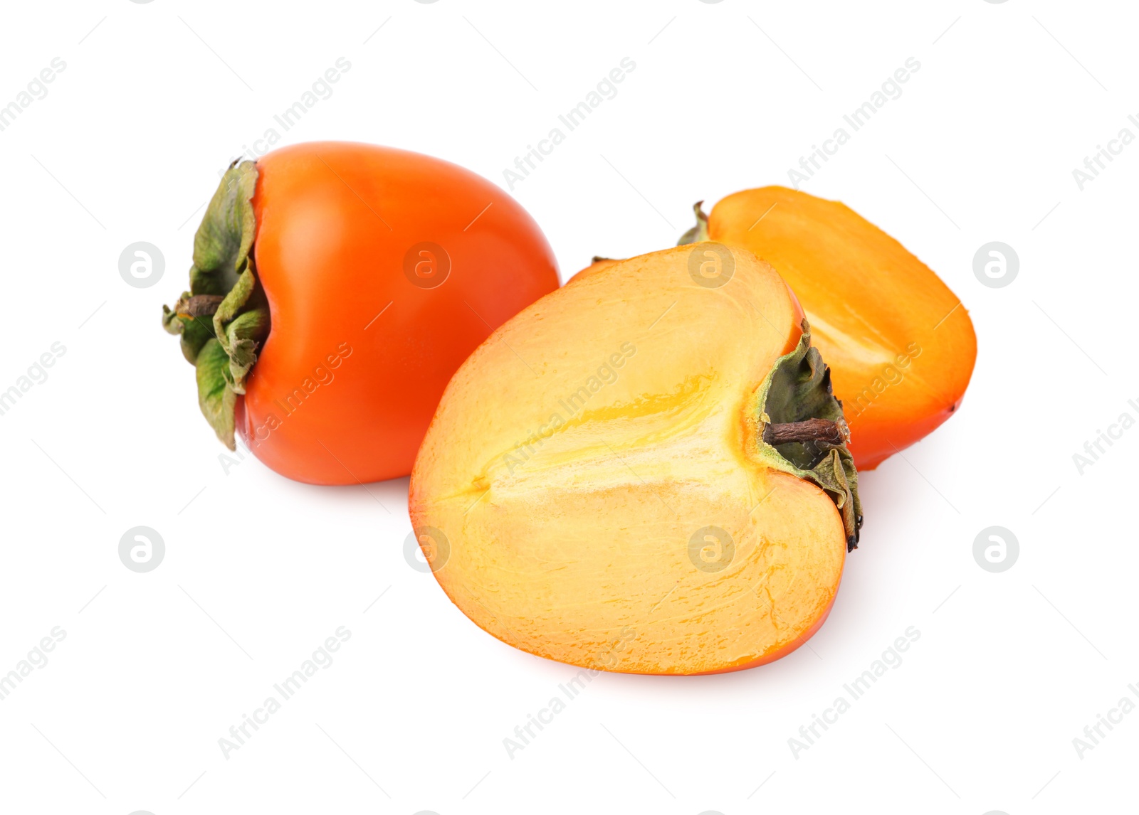 Photo of Whole and cut fresh persimmons isolated on white