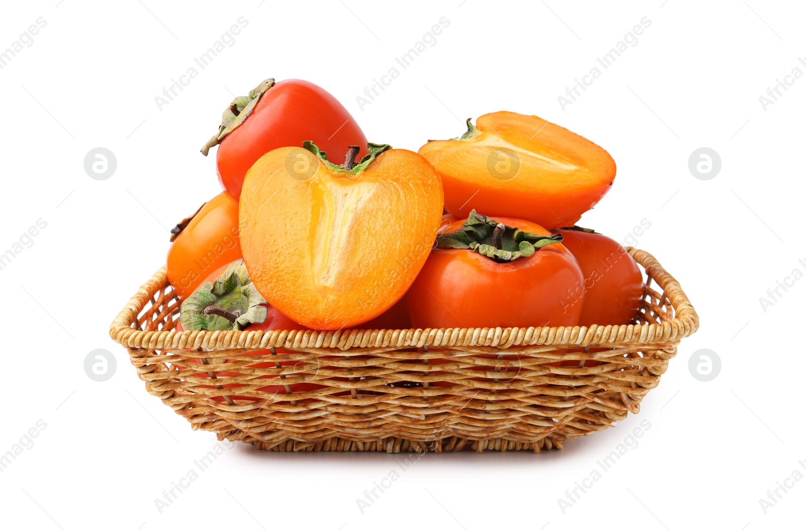 Photo of Delicious fresh juicy persimmons in wicker basket isolated on white