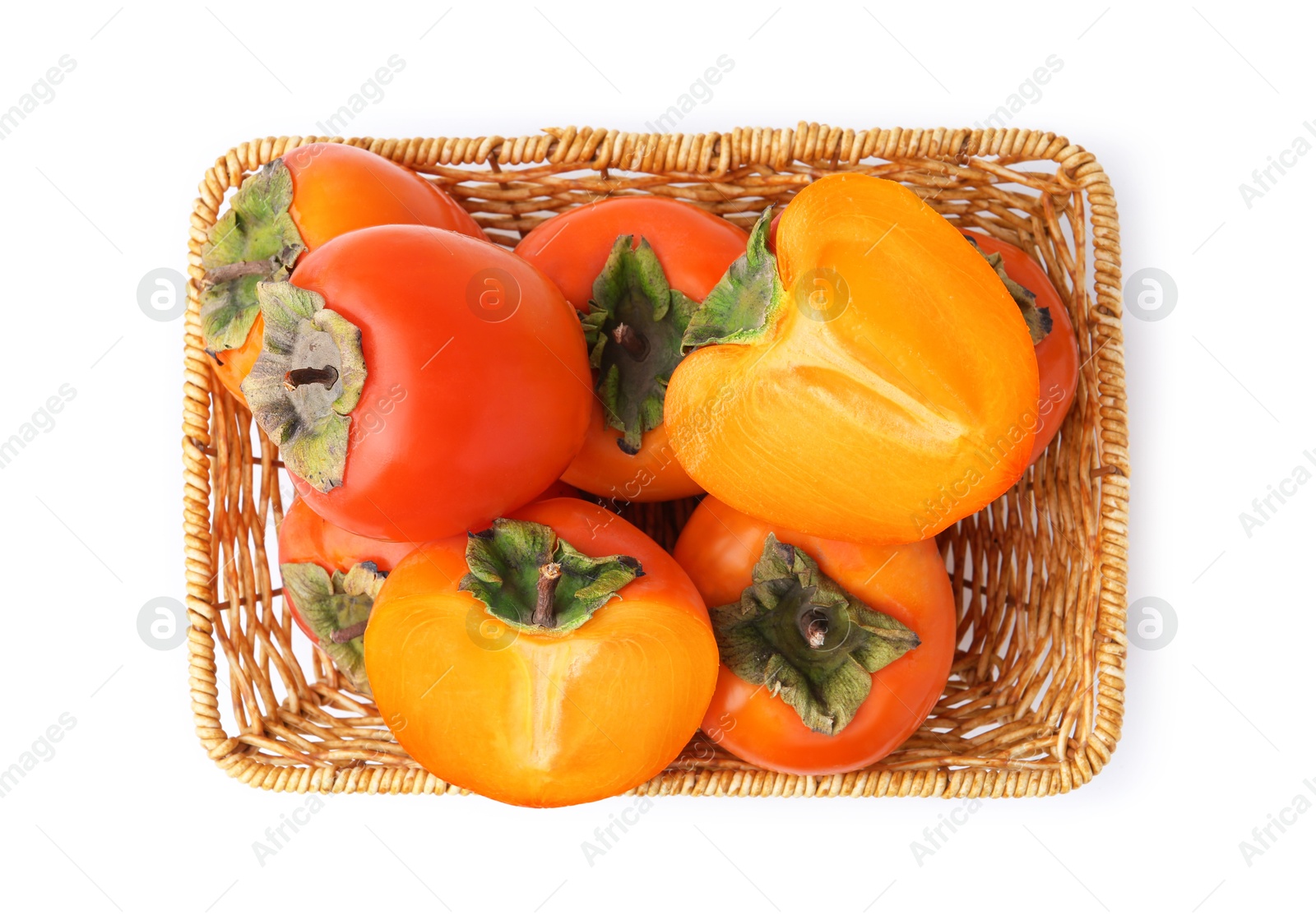 Delicious fresh juicy persimmons in wicker basket isolated on white, top view Photo of Delicious fresh juicy persimmons in wicker basket isolated on white, top view