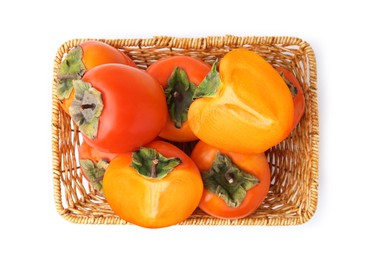 Photo of Delicious fresh juicy persimmons in wicker basket isolated on white, top view