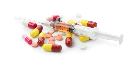 Photo of Drug addiction. Different pills and syringe isolated on white