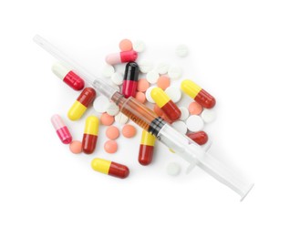 Photo of Drug addiction. Different pills and syringe isolated on white, top view