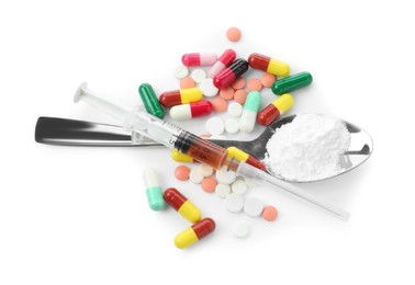 Photo of Drug addiction. Different pills, spoon with powder and syringe isolated on white, top view