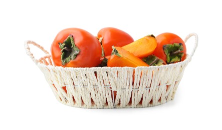 Photo of Ripe persimmons in wicker basket isolated on white