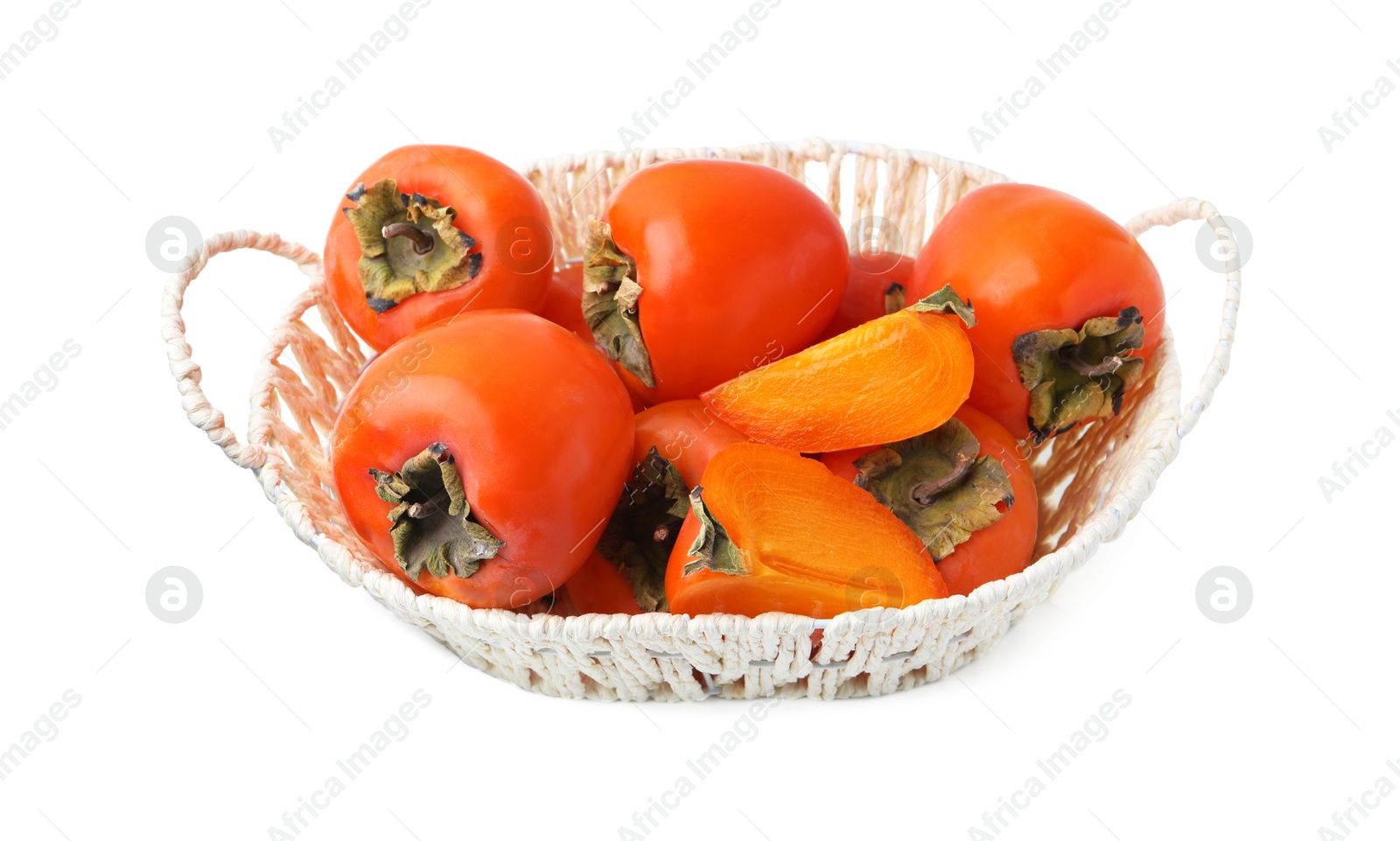 Photo of Ripe persimmons in wicker basket isolated on white