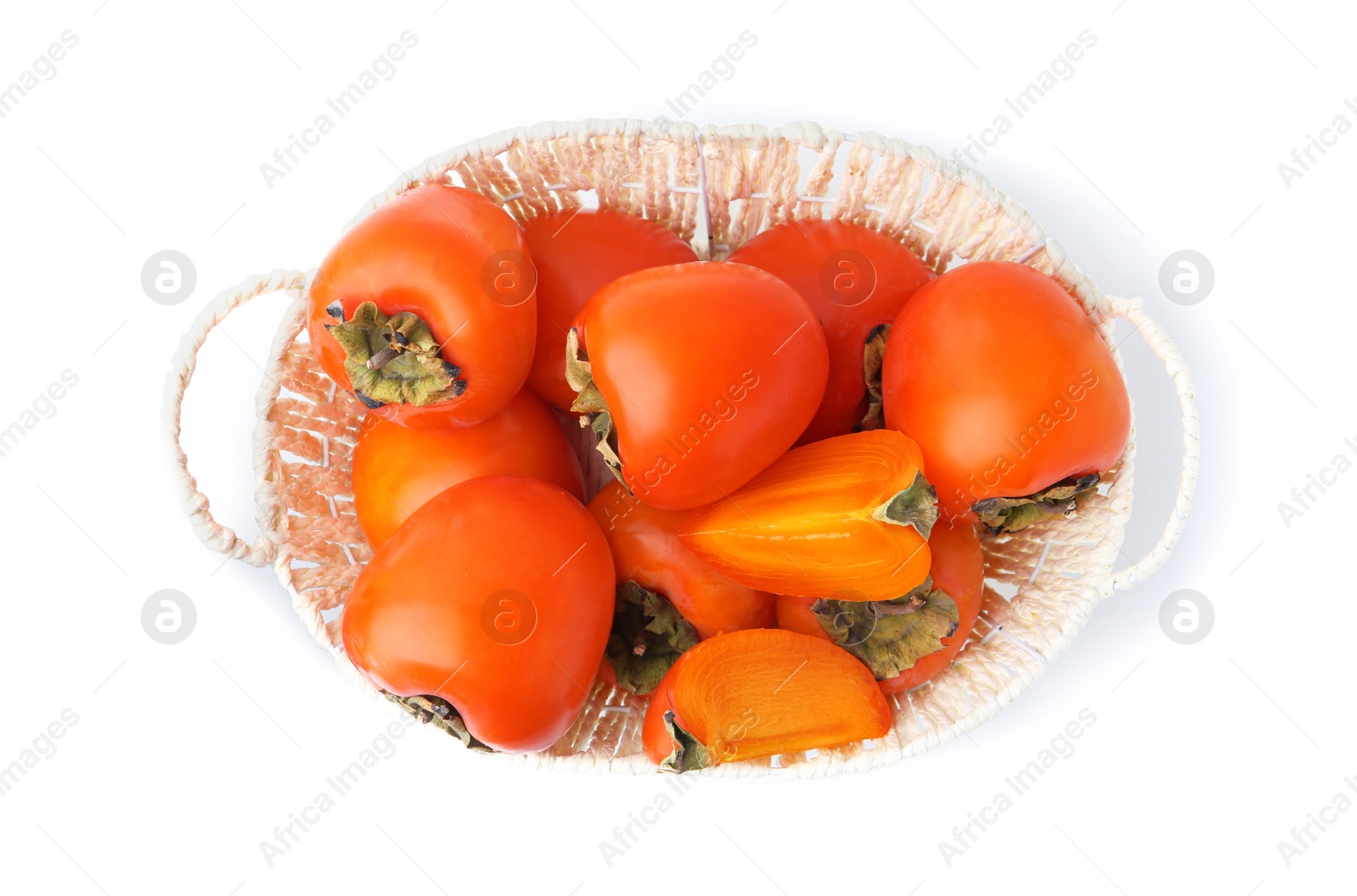 Photo of Ripe persimmons in wicker basket isolated on white, top view