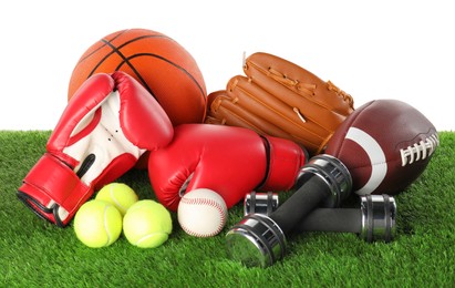 Photo of Different sport equipment on artificial grass isolated on white