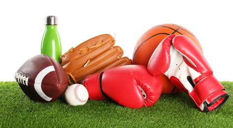 Photo of Different sport equipment on artificial grass isolated on white