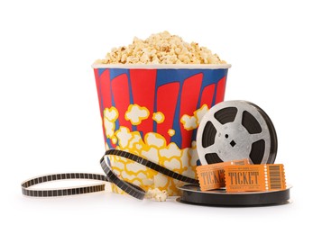 Photo of Tasty popcorn, film reels and movie tickets isolated on white