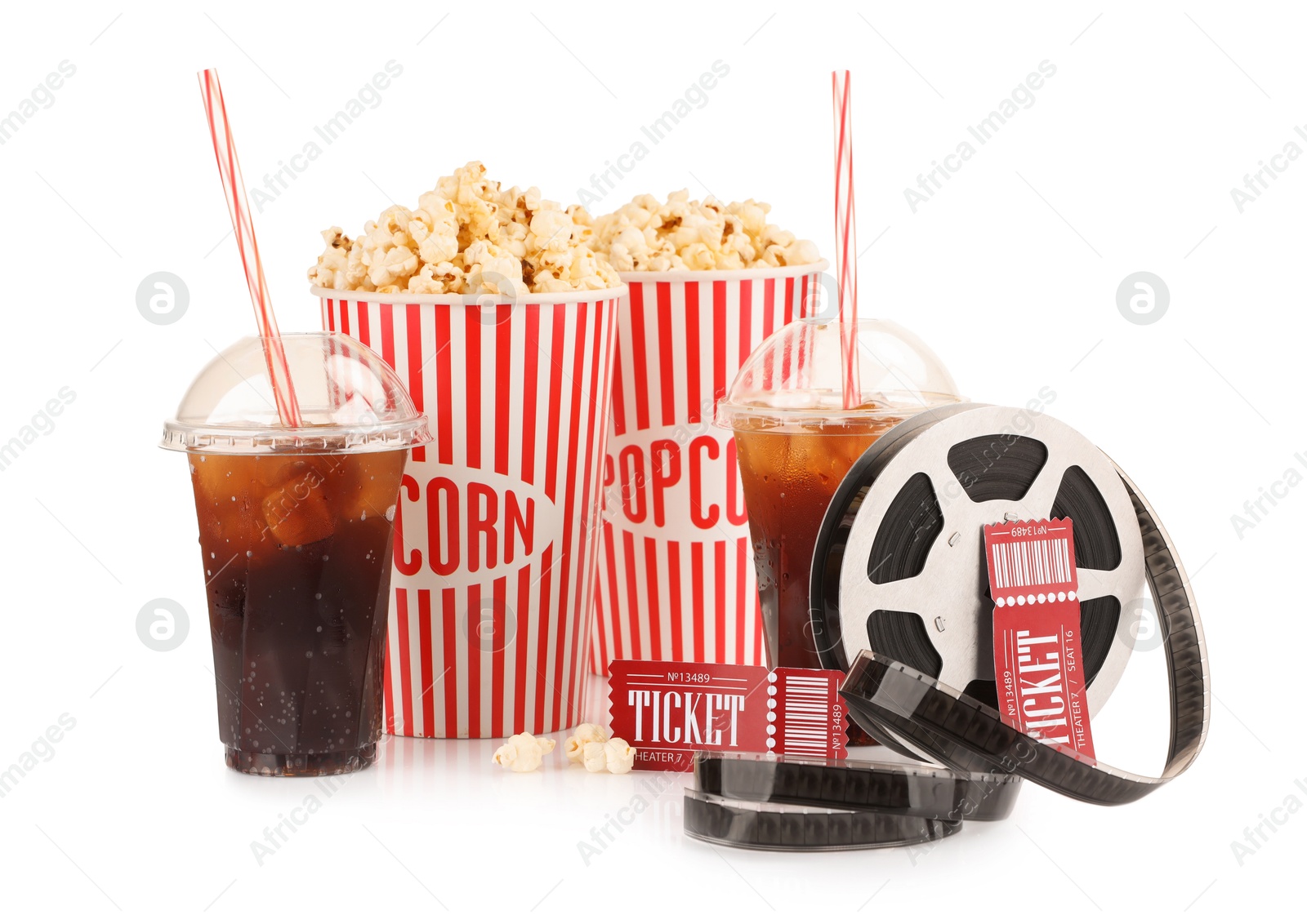 Photo of Tasty popcorn, film reel, soda drinks and movie tickets isolated on white