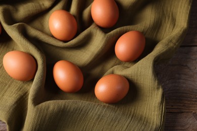 Photo of Many fresh eggs on wooden table, above view