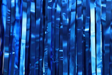 Photo of Shiny blue foil curtain as background, closeup