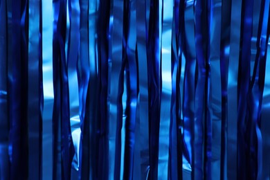 Photo of Shiny blue foil curtain as background, closeup