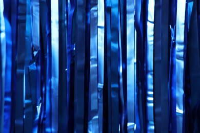 Photo of Shiny blue foil curtain as background, closeup