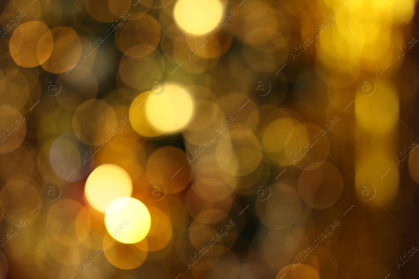 Photo of Blurred view of shiny golden lights as background. Bokeh effect