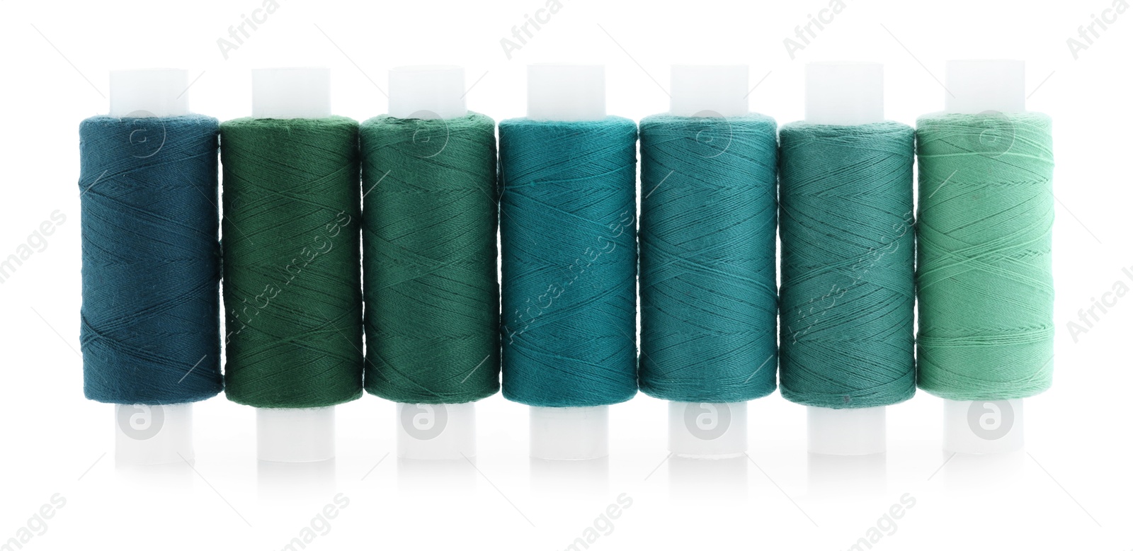 Photo of Spools of bright sewing threads isolated on white