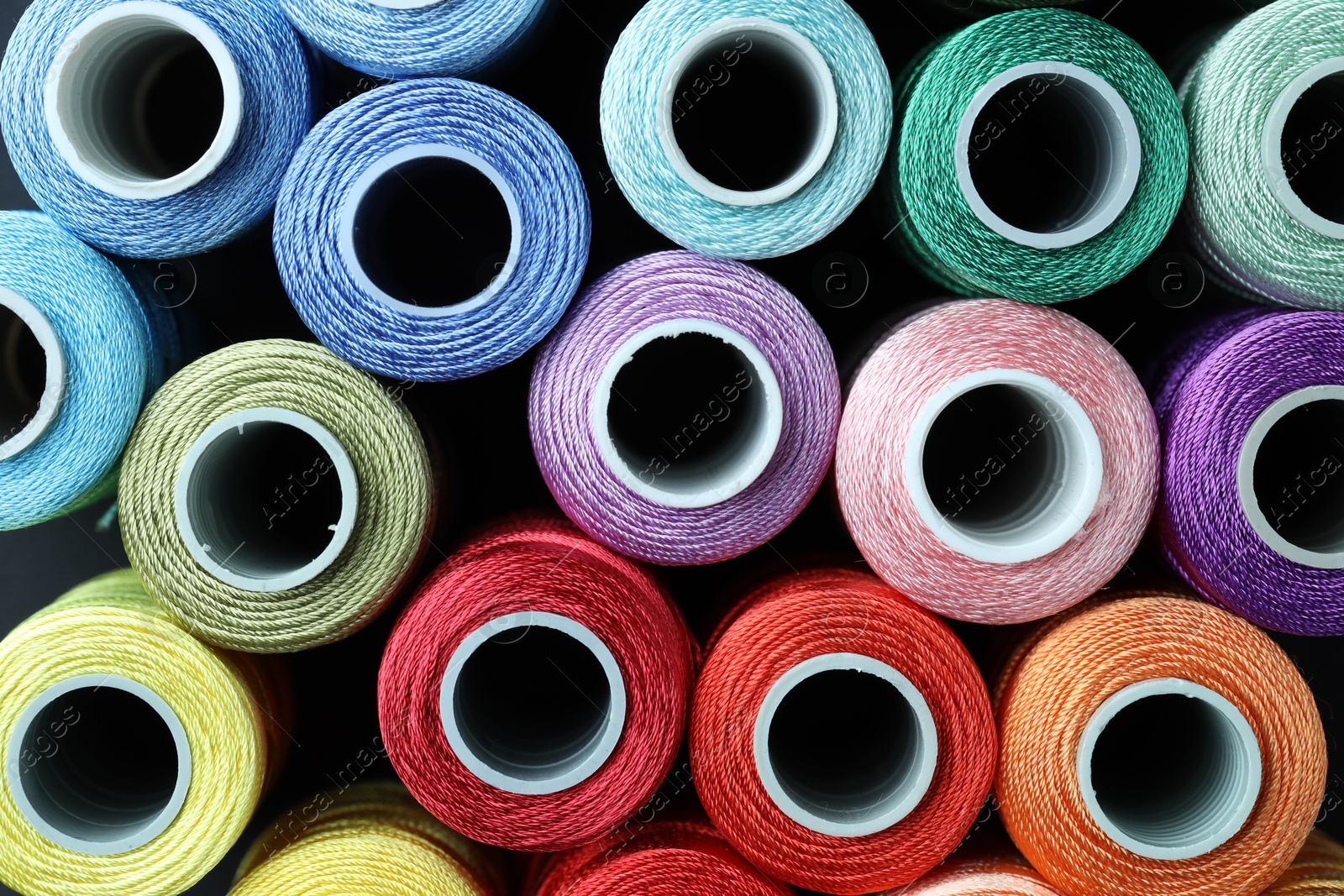 Photo of Spools of bright sewing threads, top view