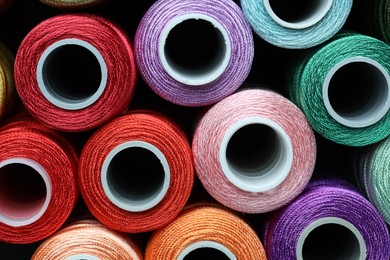 Photo of Spools of bright sewing threads, top view