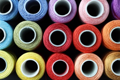 Photo of Spools of bright sewing threads, top view