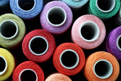 Photo of Spools of bright sewing threads, top view