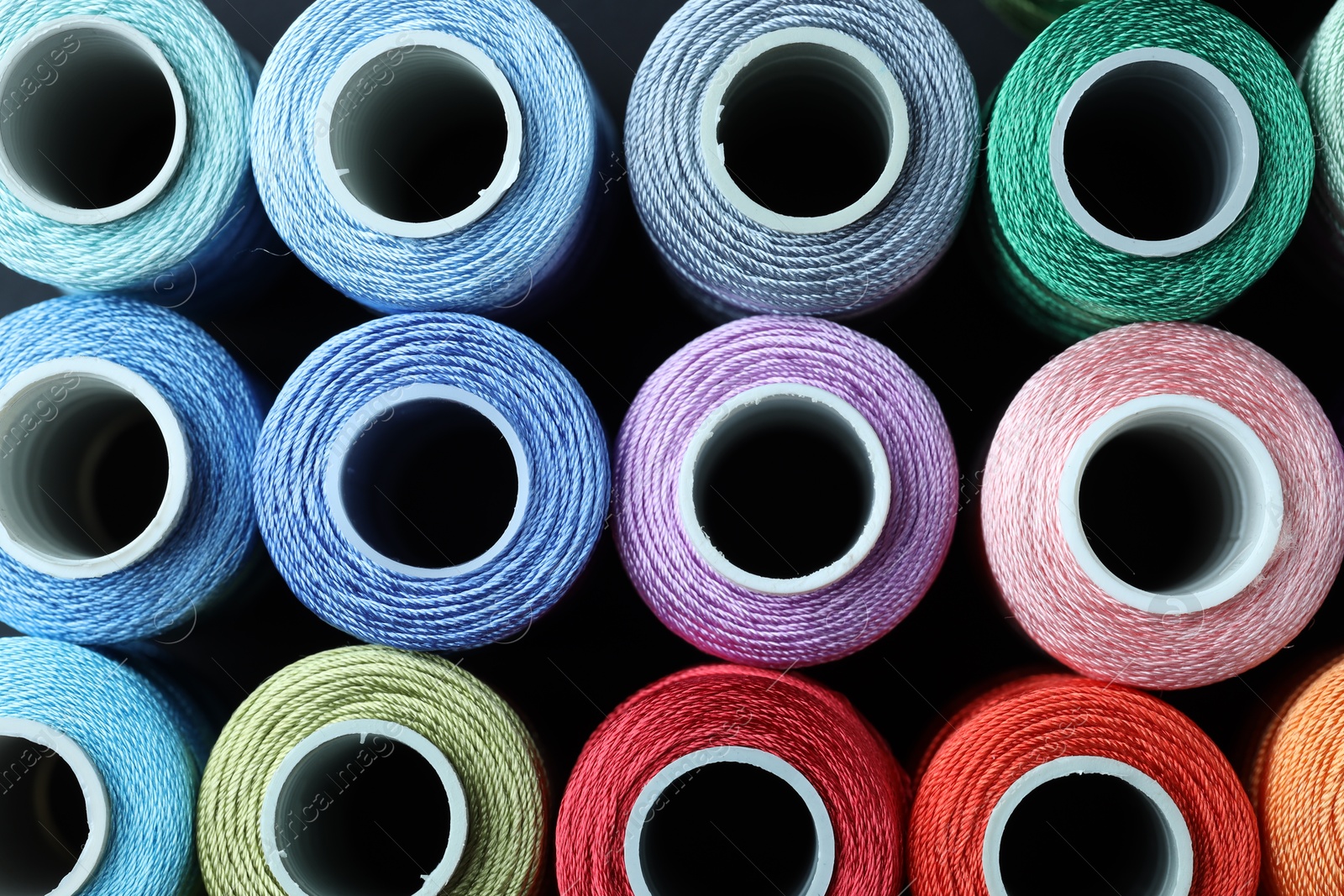 Photo of Spools of bright sewing threads, top view