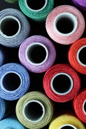 Photo of Spools of bright sewing threads, top view