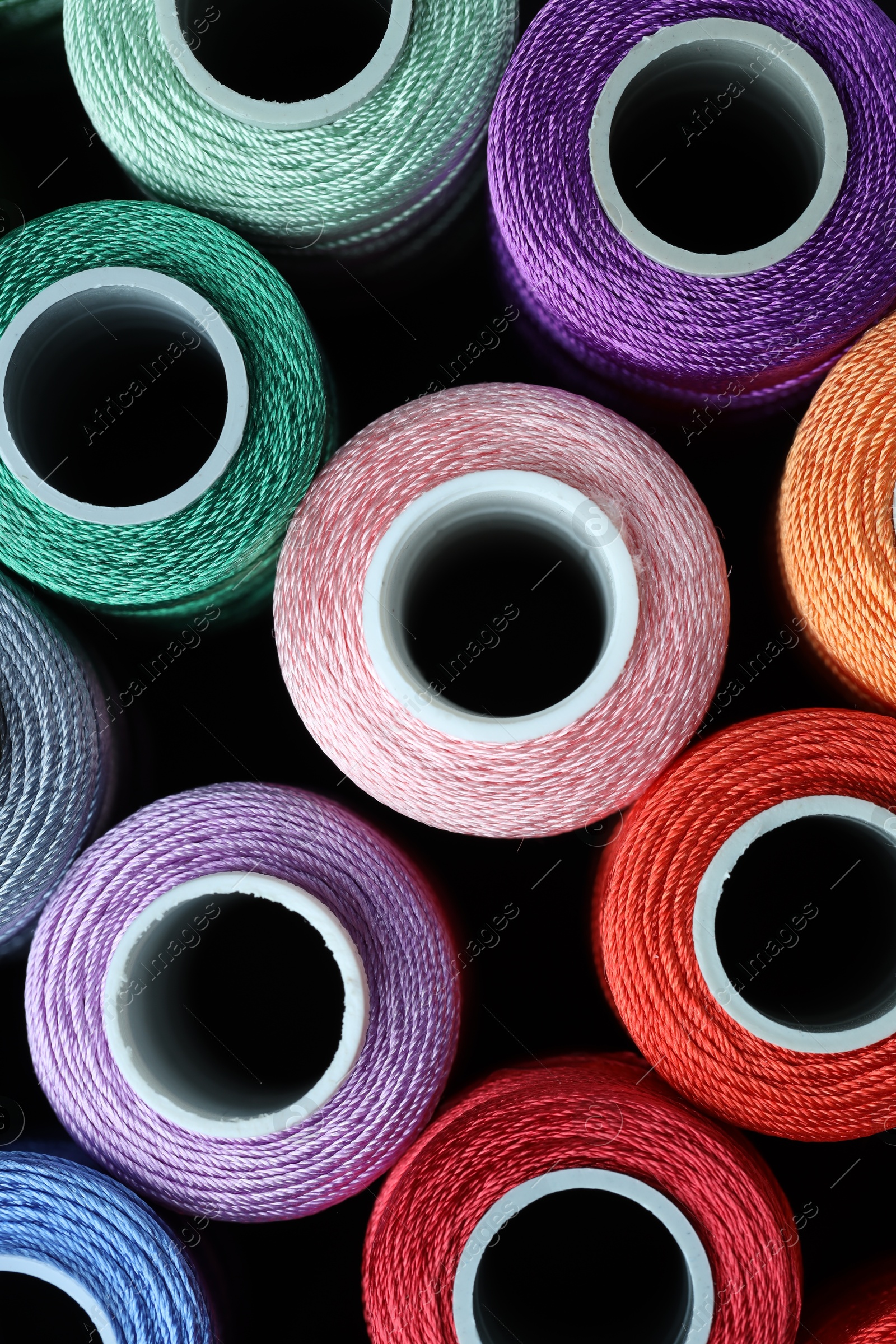 Photo of Spools of bright sewing threads, top view