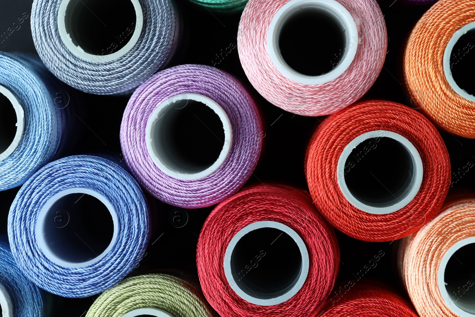 Photo of Spools of bright sewing threads, top view