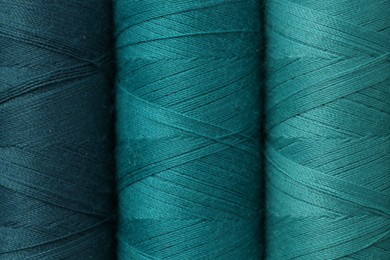 Photo of Spools of colorful sewing threads as background, top view