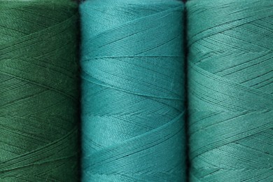 Photo of Spools of colorful sewing threads as background, top view