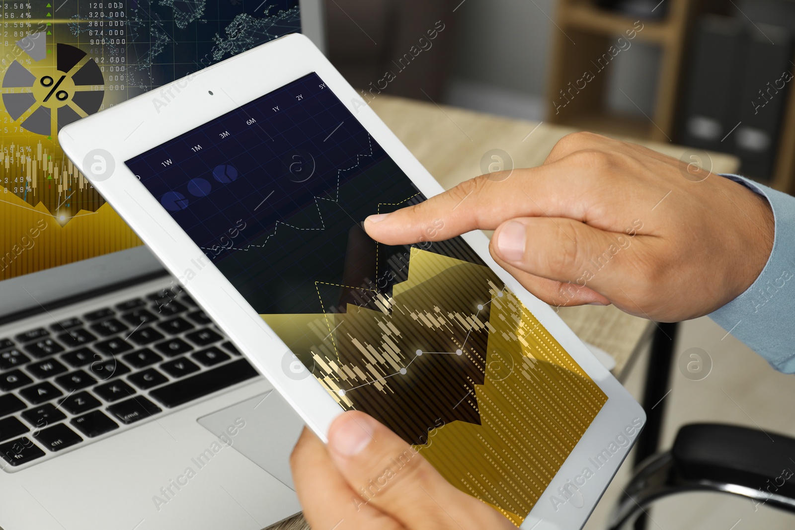 Image of Stock exchange. Man analysing financial market on tablet and laptop, closeup. Charts and information. Planning trading and investing