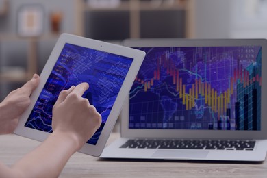 Image of Stock exchange. Woman analysing financial market on tablet and laptop, closeup. Charts and information. Planning trading and investing