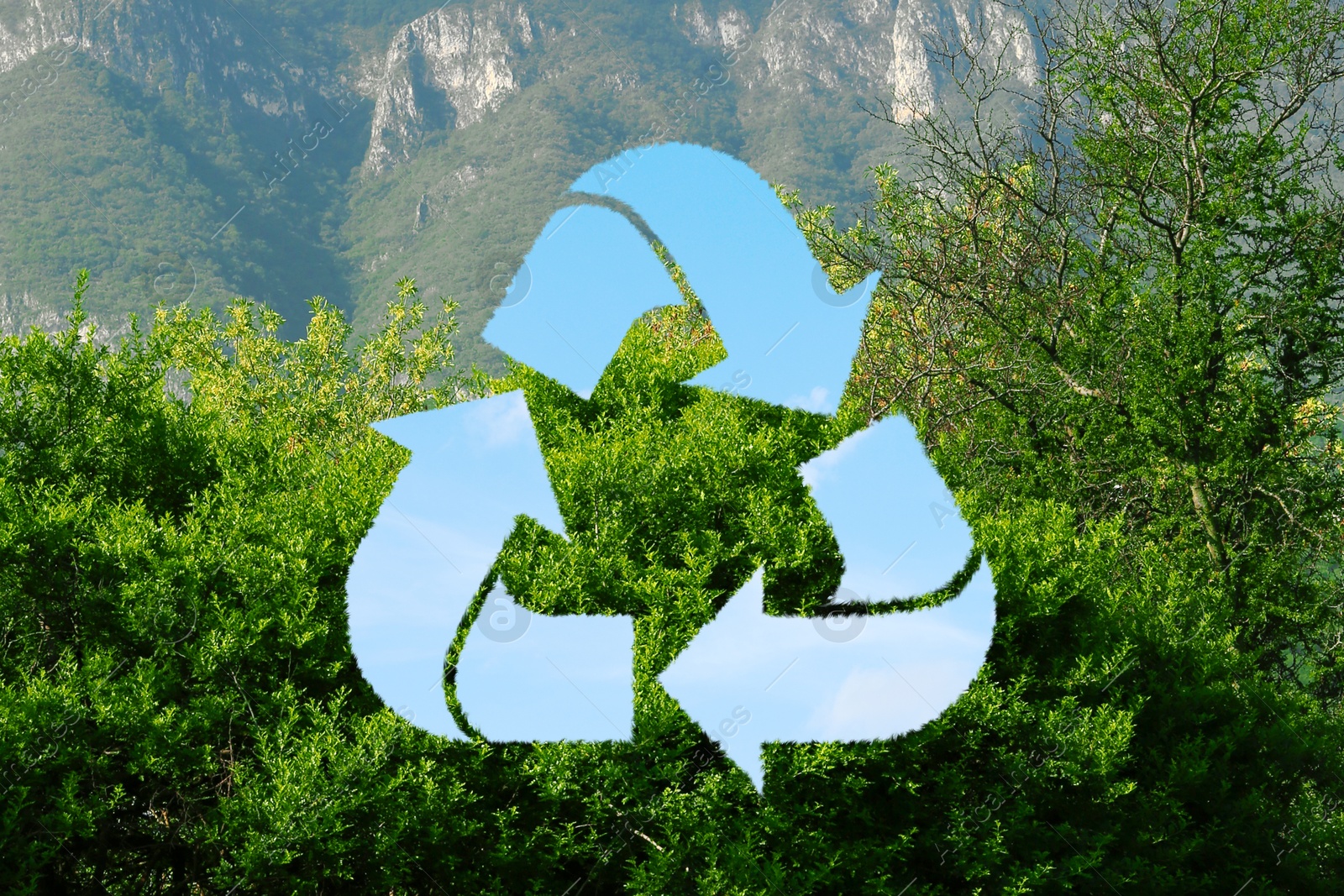 Image of Save Earth. Recycling symbol with blue sky inside against mountain landscape