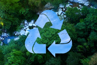 Image of Save Earth. Recycling symbol with blue sky inside against aerial landscape