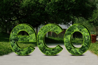 Image of Save Earth. Word Eco with green plants inside in park