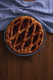 Photo of Delicious currant pie on wooden table, flat lay. Space for text