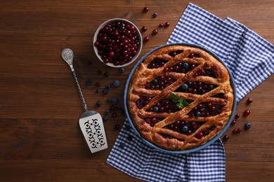 Photo of Delicious currant pie with fresh berries on wooden table, flat lay