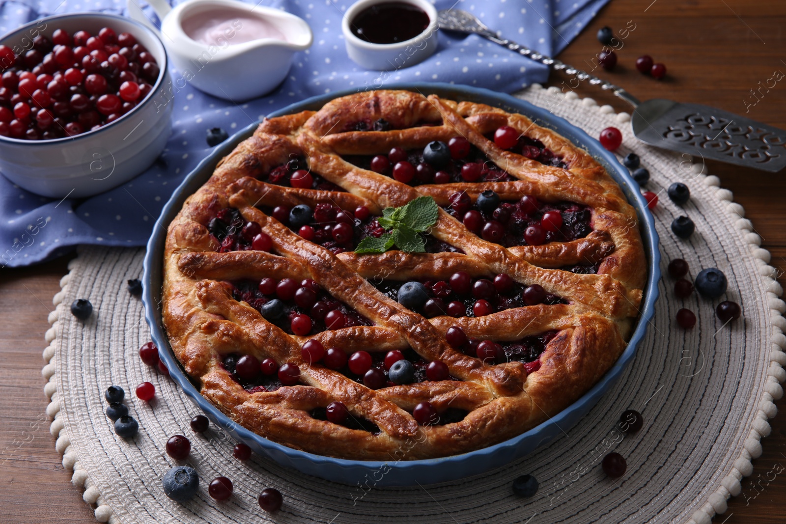 Photo of Delicious currant pie with fresh berries on wooden table