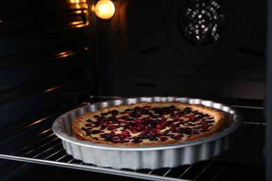 Photo of Delicious homemade currant pie in oven, closeup