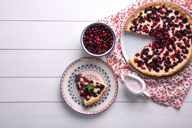 Photo of Delicious currant pie and fresh berries on white wooden table