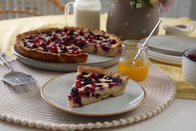 Photo of Piece of delicious currant pie on white table indoors